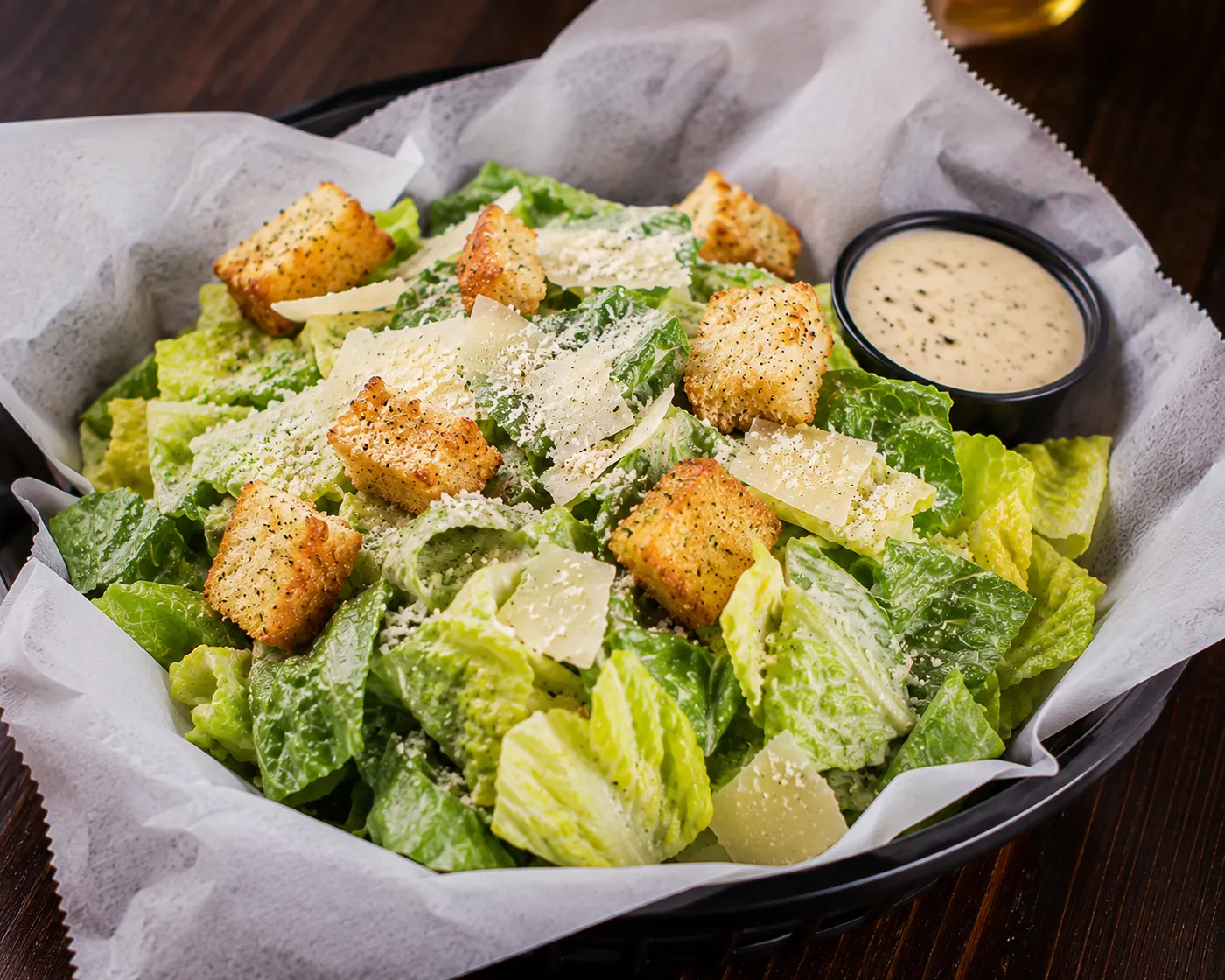 Fresh Caesar salad with parmesan and croutons at Buzz City