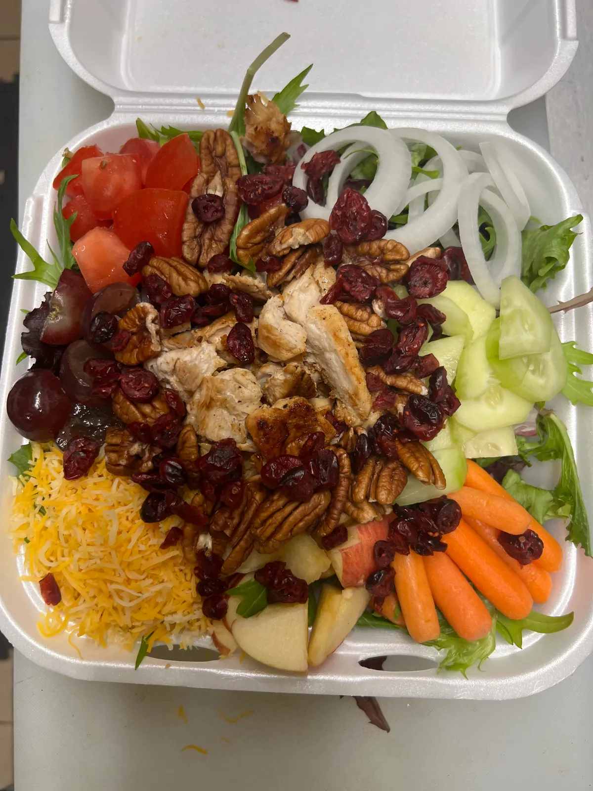 Buzz City Signature Salad with grilled chicken, pecans, cranberries, apples and cheddar