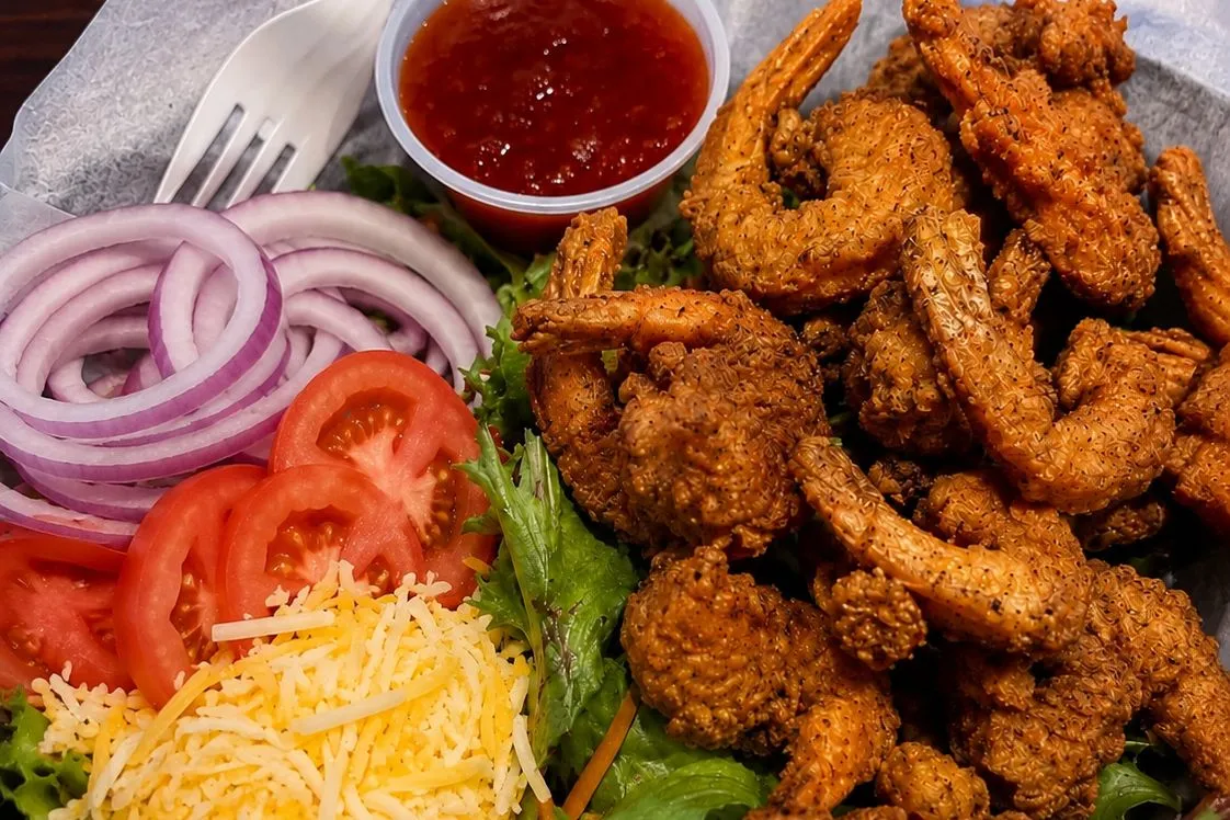 Buzz City shrimp salad with fried shrimp, lettuce, tomato and cheese in Charlotte